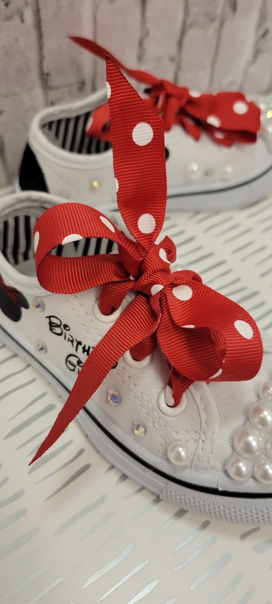 Personalized (name and character) canva pair of sneakers.